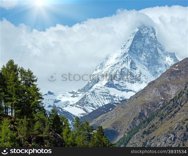 Summer Matterhorn mountain view and sunshine in blue sky (Alps, Switzerland, Zermatt)