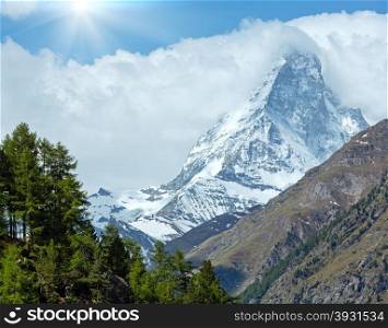 Summer Matterhorn mountain view and sunshine in blue sky (Alps, Switzerland, Zermatt)
