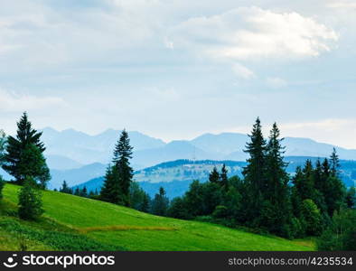 Summer misty evening village outskirts with Tatra range (Gliczarow Gorny, Poland)