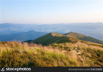 summer misty mountain landscape with christian cross on top (Ukraine, Carpathian Mountains)