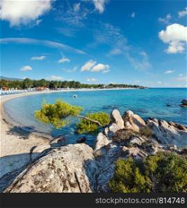 Summer morning Platanitsi beach on Sithonia Peninsula, Chalcidice, Greece. People are unrecognizable.