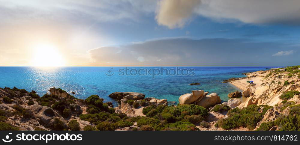 Summer morning rocky Aegean sunshiny coast with sandy beach and camping near Platanitsi Beach, Sithonia Peninsula, Chalcidice, Greece. Multi shots high-resolution panorama.