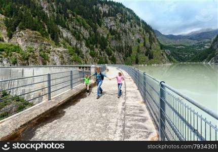 Summer mountain canyon and family near dam (Switzerland)