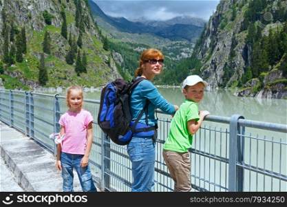 Summer mountain canyon and family on dam (Switzerland)