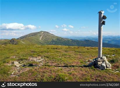 summer mountain landscape with direction sign