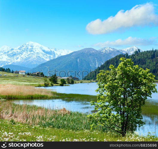 Summer mountain landscape with lake Lago di Resia and blue cloudy sky (Italy). Two shots stitch image.