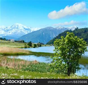 Summer mountain landscape with lake Lago di Resia and blue cloudy sky (Italy). Two shots stitch image.