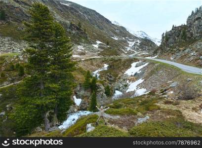 Summer mountain landscape with road, stream and boy near (Fluela Pass, Switzerland)