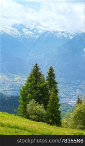 Summer mountain landscape with snow on mount top and town in valley (Alps, Switzerland)