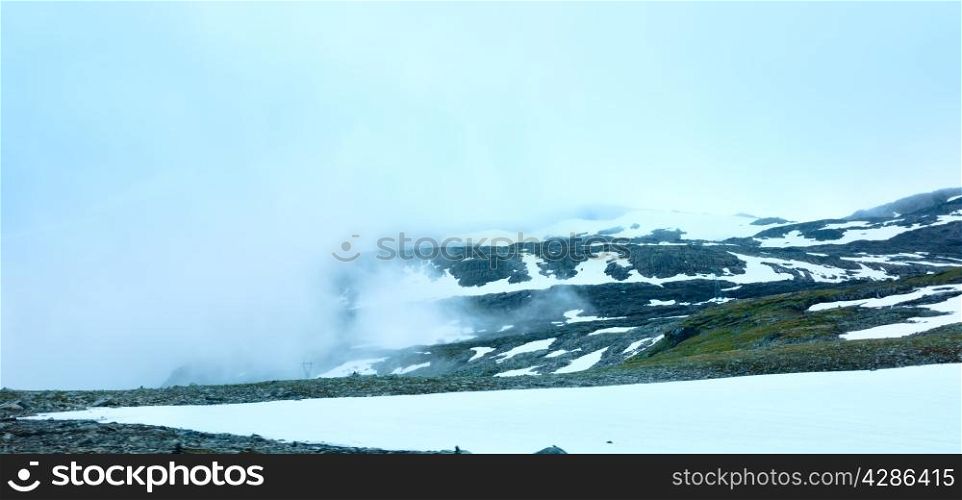 Summer mountain misty landscape with snow (Norway, Aurlandsfjellet).
