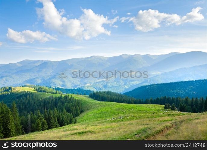Summer mountain plateau landscape with dirty road on hill top