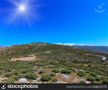 Summer mountain sunshiny landscape with alpine road (Sierra Nevada National Park, near Granada, Spain).