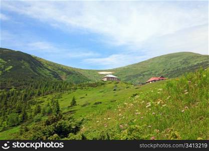 Summer mountain view with flowers and some snow on mountainside (with weather and biological stations buildings on Chornogora Ridge, Carpathian, Ukraine)