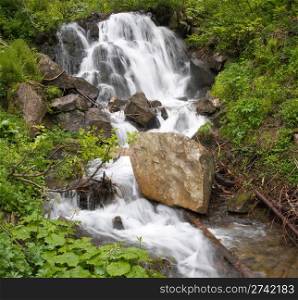 Summer mountain waterfall ( Carpathian mountains, Ukraine). Two shots stitch image.
