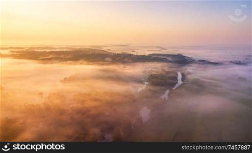 Summer nature landscape aerial panorama. Morning fog over river, meadow and forest. Nature sunlight scene at foggy sunrise. Belarus, Europe