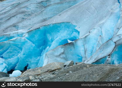 Summer Nigardsbreen Glacier on rocky slope ( Norway).