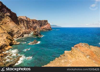 Summer ocean with rocky shore in sunny day, Portugal. Ocean with mountains