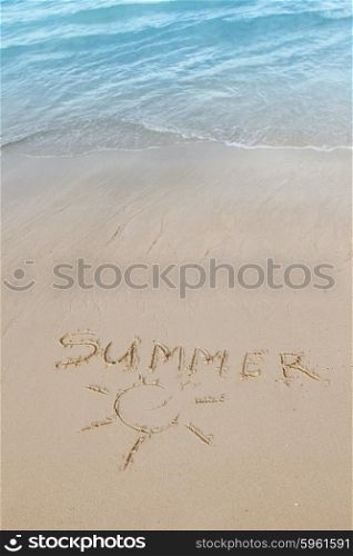 Summer on beach concept. Summer on beach concept - inscription on a beach sand with coming wave