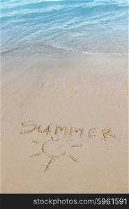 Summer on beach concept. Summer on beach concept - inscription on a beach sand with coming wave