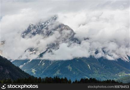 Summer overcast mountain top in clouds view from Fernpass, Austria, near Zugspitze mountain.