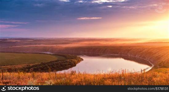 Summer panorama of river in canyon. Panoramic view from the hill on bend of the river Dniester at sunset.