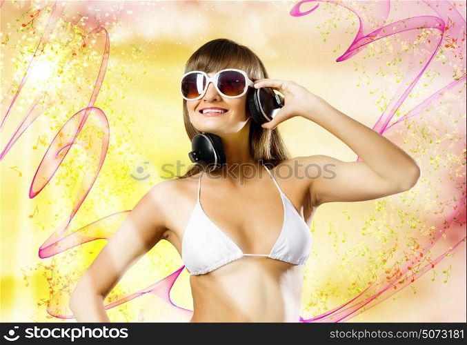 Summer party. Attractive girl in white bikini and headphones