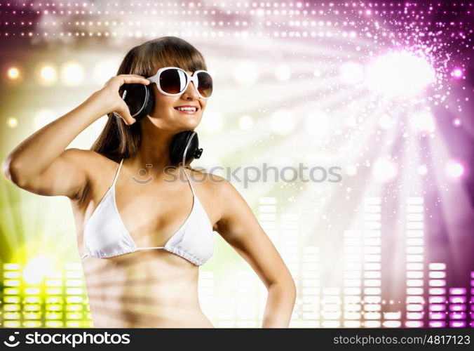 Summer party. Young pretty girl in white bikini and headphones