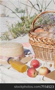 Summer - picnic by the sea. basket for a picnic with with buns, apples and juice