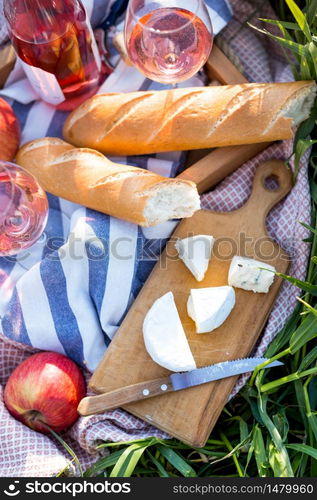 Summer - picnic in the meadow. baguette on green grass