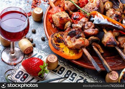 Summer picnic with shashlik and lotto board game.Barbecue and board games.Kebab. BBQ meat and lotto game