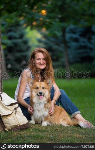 summer - portrait of a corgi fluffy and his owner