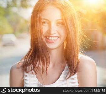 Summer portrait of a happy girl full of sunshine.