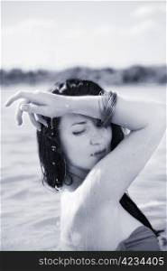 summer portrait of attractive woman in water