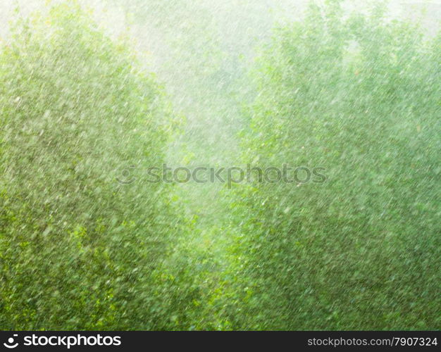 Summer rainy outside window, water drops droplets raindrops on glass windowpane as background texture. Downpour rain.