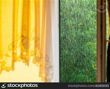 Summer rainy outside window, water drops droplets raindrops on glass windowpane. Downpour rain.