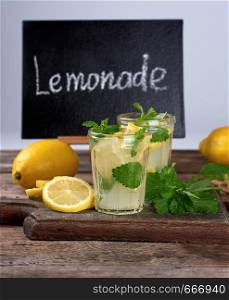 summer refreshing drink lemonade with lemons, mint leaves in a glass,