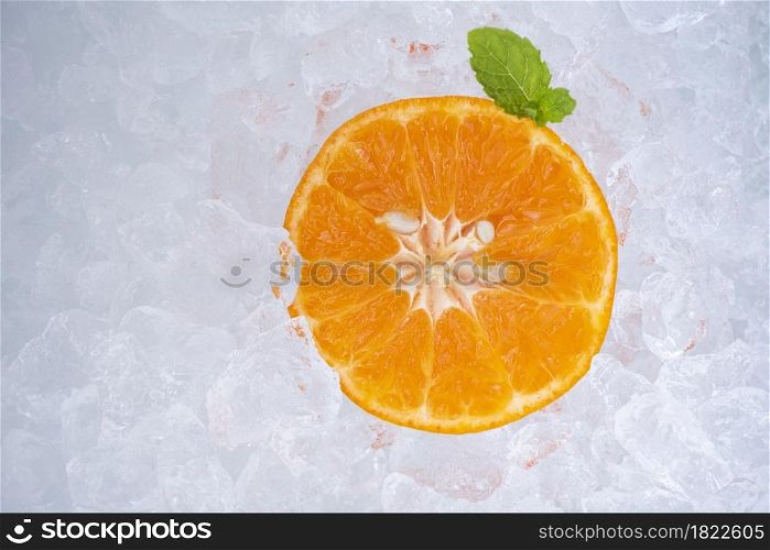 Summer refreshing of cold drinks fresh fruit orange slice on ice with mint leaf, top view