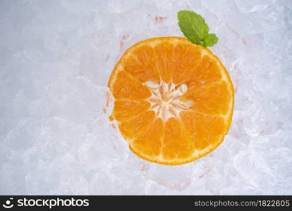 Summer refreshing of cold drinks fresh fruit orange slice on ice with mint leaf, top view