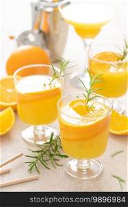 Summer refreshing orange cocktail with rosemary and fresh fruits