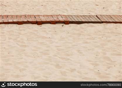 Summer resort and vacation. Wooden planks of sidewalk on a sandy beach sea coast.