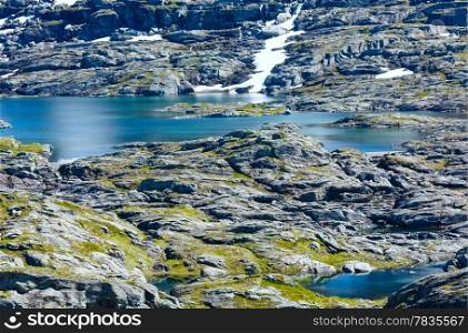 Summer rocky mountain view with small lake (Norway). Pathway to Trolltunga.