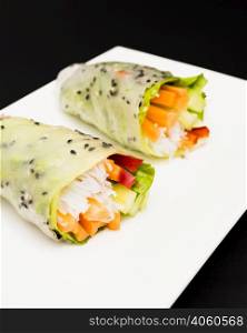 summer roll filled with colorful vegetables white plate
