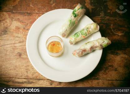Summer rolls and fish sauce on a plate