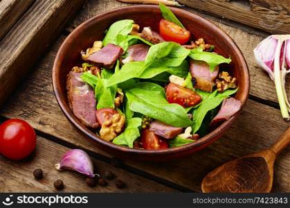 Summer salad with fresh herbs.Salad with spinach,bacon and sorrel. Spinach salad and sorrel