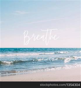 Summer sand beach and seashore waves background. Defocused blurred square holiday vacations concept with motivational quote Breathe