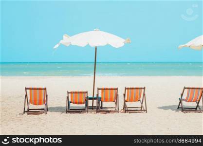 Summer sea beach empty chair umbrella with blue ocean sky for travel nature background