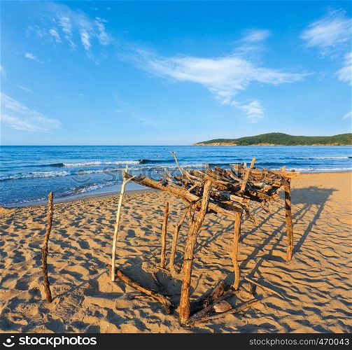 Summer sea coast view with sandy beach and small wooden awning from sun, Bulgaria