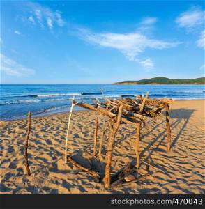 Summer sea coast view with sandy beach and small wooden awning from sun, Bulgaria