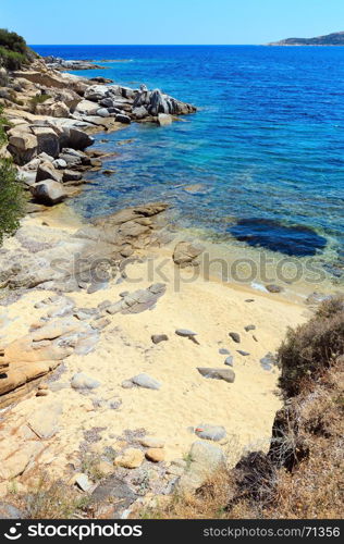 Summer sea scenery with aquamarine transparent water and sandy beach. View from shore (Sithonia, Halkidiki, Greece).