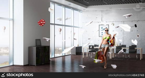 Summer shopping time. Young woman in swimsuit with shopping bags in modern office